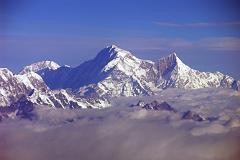 
Shishapangma, the 14th highest mountain in the world at 8012m, shines in the early morning sun from Kathmandu’s Mountain flight. The steep and treacherous southwest face is in shadow on the left. The north face is just visible in the sun on the right. On the far right the pointy rocky peak is Phola Gangchen (7716m), first climbed in 1981, and to its left is Shishapangma’s East face.

